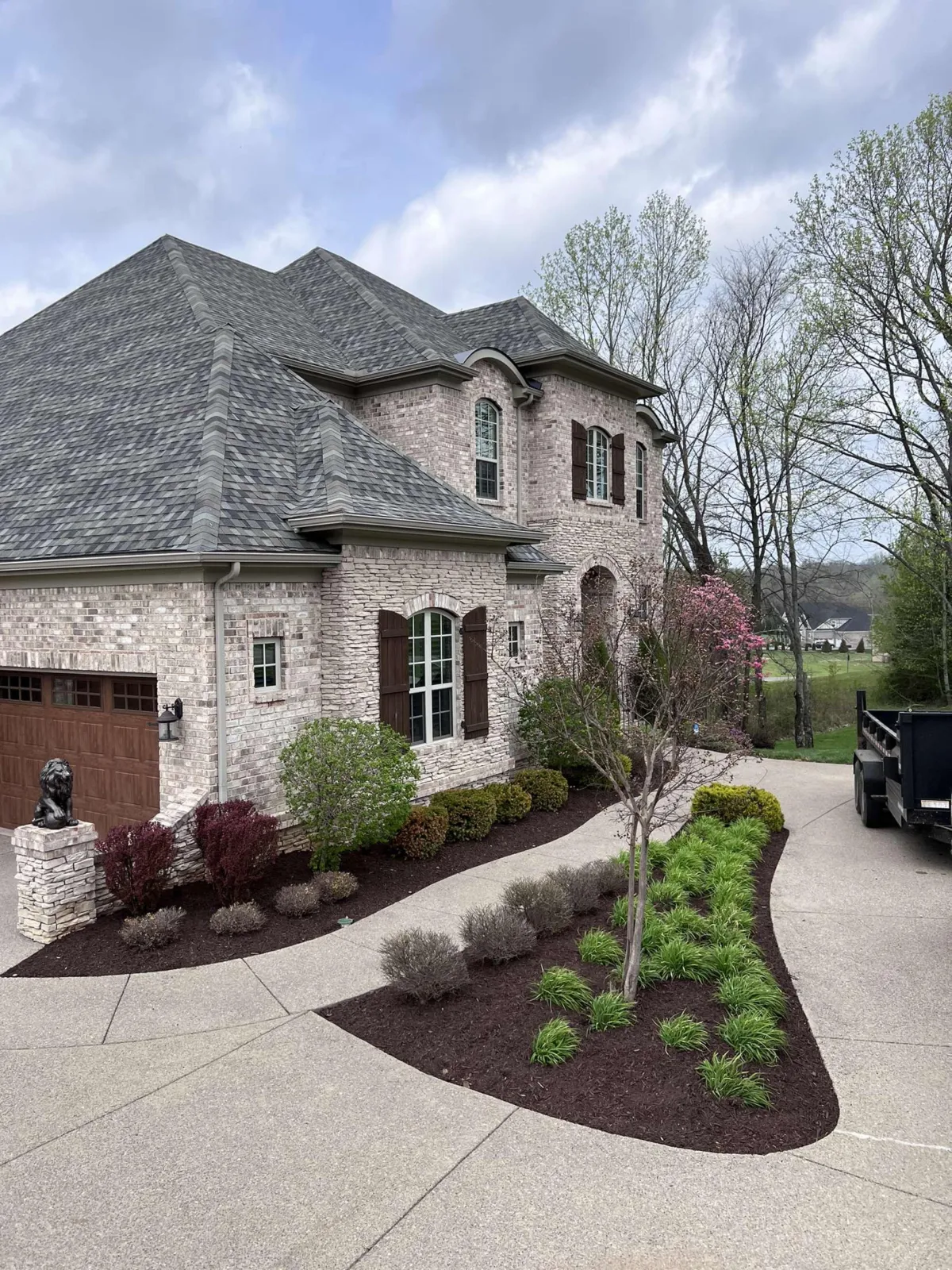 Luxury home with professionally designed landscape and curved driveway